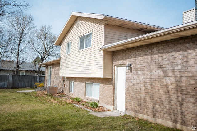 20 E 9n Cir N, American Fork, UT 84003 - view of side of property with fence, brick siding, a chimney, and a lawn