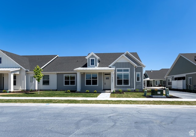 3782 S 4250 W Unit 429C, West Haven, UT 84401 - view of front of property featuring board and batten siding, a shingled roof, and a front lawn