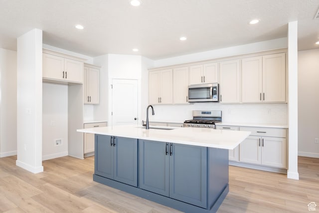 3782 S 4250 W Unit 429C, West Haven, UT 84401 - kitchen with appliances with stainless steel finishes, a sink, light wood-type flooring, light countertops, and recessed lighting