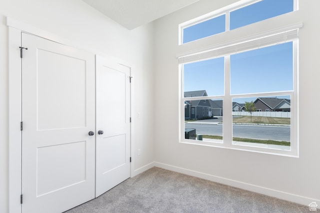 3782 S 4250 W Unit 429C, West Haven, UT 84401 - unfurnished bedroom with light colored carpet, baseboards, and a closet