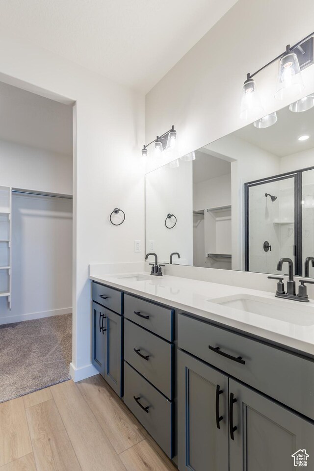 3782 S 4250 W Unit 429C, West Haven, UT 84401 - bathroom featuring a shower stall, double vanity, and wood finished floors