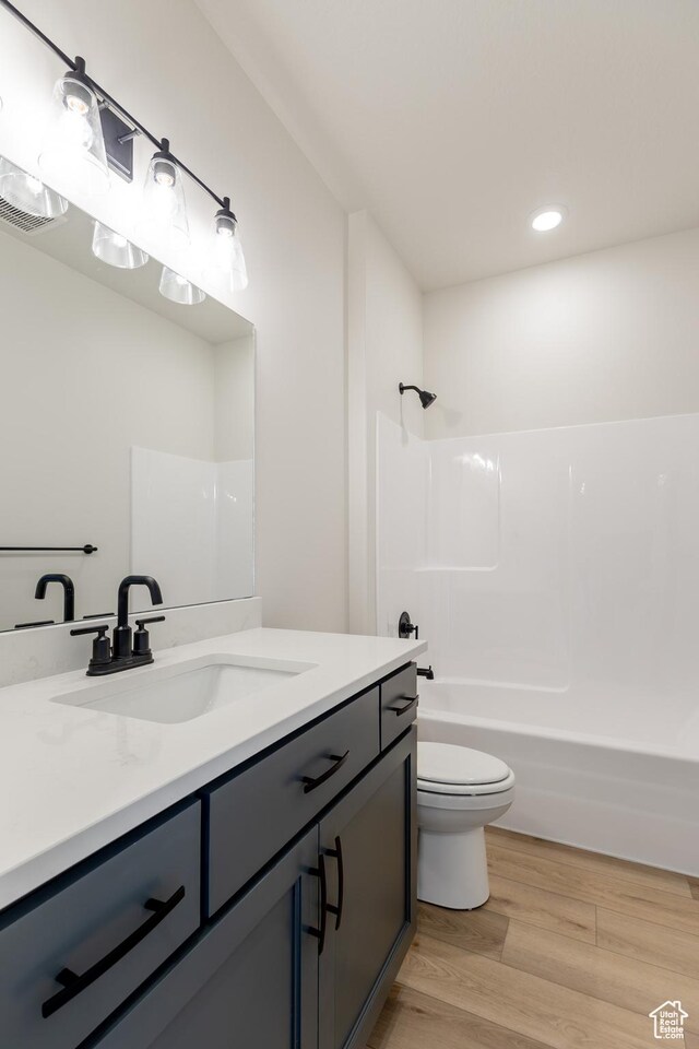 3782 S 4250 W Unit 429C, West Haven, UT 84401 - bathroom with toilet, wood finished floors, recessed lighting, vanity, and washtub / shower combination