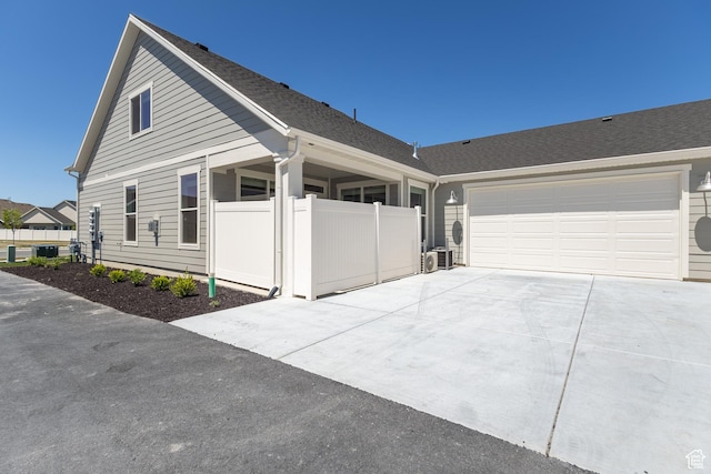 3782 S 4250 W Unit 429C, West Haven, UT 84401 - view of front of home with concrete driveway, a garage, roof with shingles, and fence