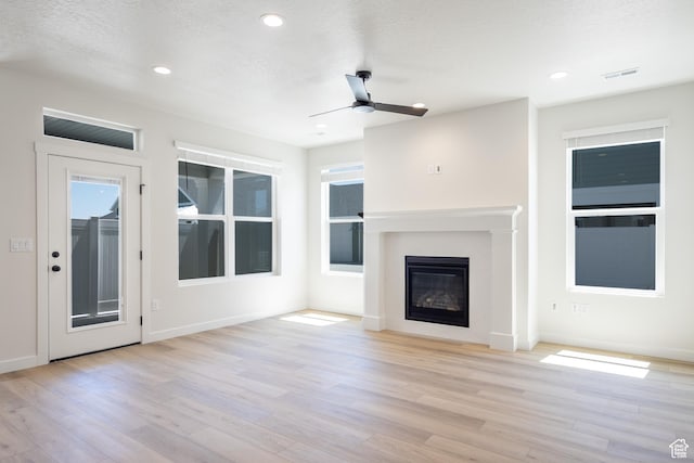 3782 S 4250 W Unit 429C, West Haven, UT 84401 - unfurnished living room with wood finished floors, ceiling fan, baseboards, a glass covered fireplace, and recessed lighting
