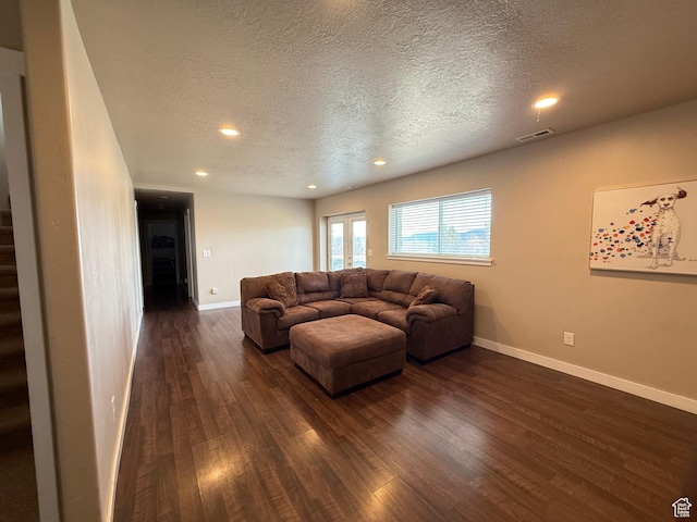 288 W Stuart Dr, Garden City, UT 84028 - living room featuring dark wood-style flooring, baseboards, visible vents, and stairs