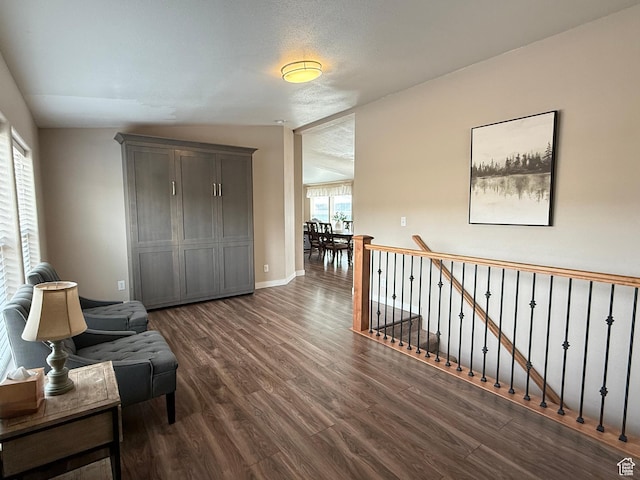 288 W Stuart Dr, Garden City, UT 84028 - living area featuring baseboards, an upstairs landing, and dark wood-style floors