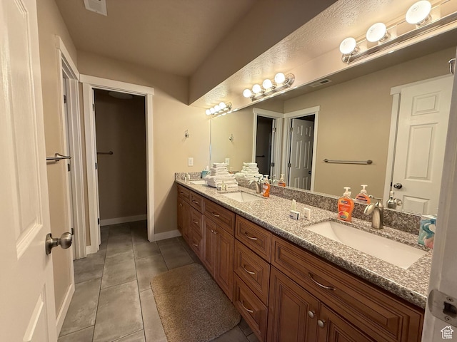 288 W Stuart Dr, Garden City, UT 84028 - full bath with a sink, baseboards, double vanity, and tile patterned flooring