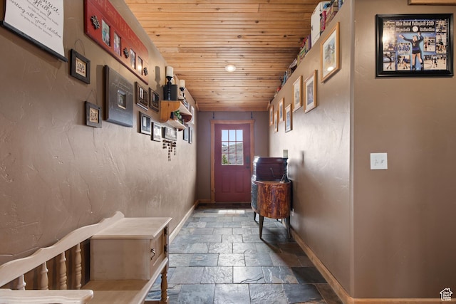 671 W Dee Dr, Garden City, UT 84028 - doorway featuring baseboards, stone tile floors, and wood ceiling