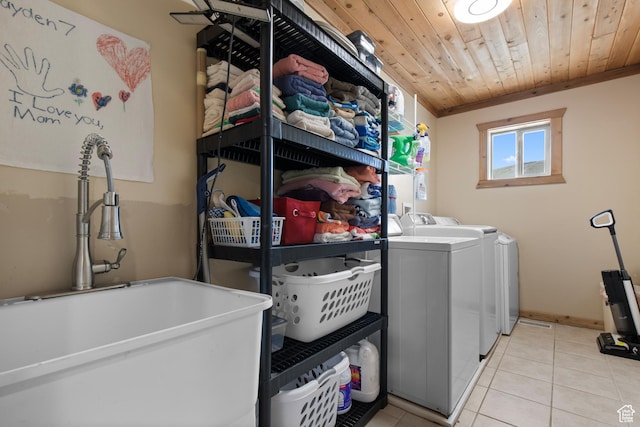 671 W Dee Dr, Garden City, UT 84028 - laundry area with light tile patterned floors, a sink, laundry area, wood ceiling, and washing machine and clothes dryer