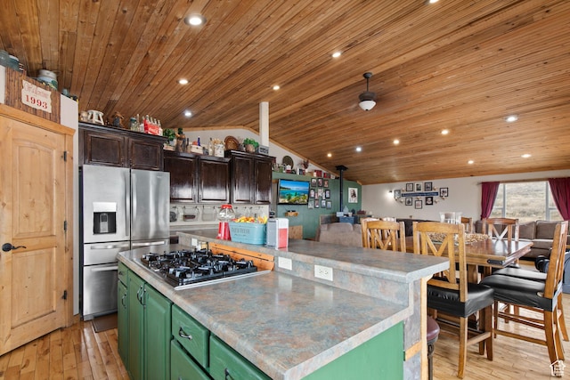 671 W Dee Dr, Garden City, UT 84028 - kitchen with light wood finished floors, vaulted ceiling, green cabinetry, and stainless steel appliances