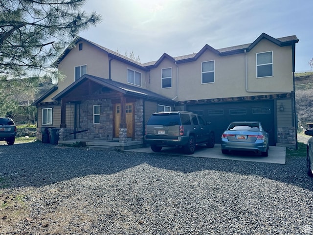 87 N Loafer Canyon Rd, Elk Ridge, UT 84651 - traditional home featuring an attached garage, stone siding, driveway, and stucco siding