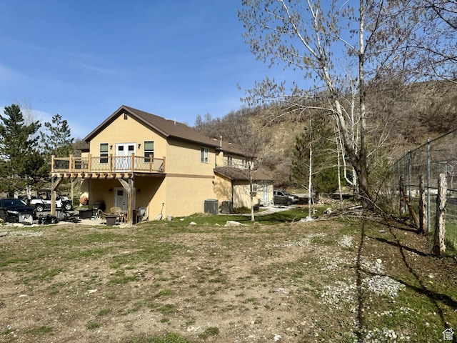 87 N Loafer Canyon Rd, Elk Ridge, UT 84651 - view of side of home featuring stucco siding, cooling unit, and a wooden deck