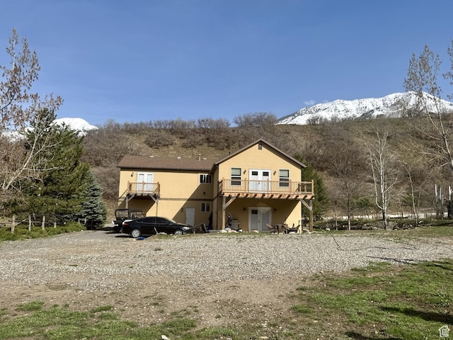 87 N Loafer Canyon Rd, Elk Ridge, UT 84651 - rear view of house with a deck with mountain view and stucco siding