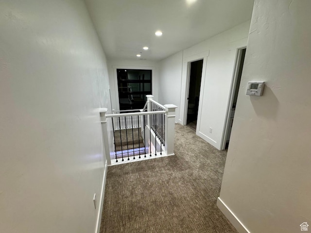 corridor featuring recessed lighting, baseboards, an upstairs landing, and carpet floors