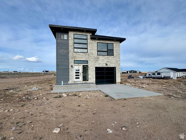 rear view of property with stone siding