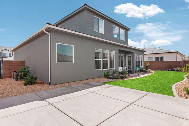 4582 S Sophia Ln, Washington, UT 84780 - back of property with central AC, a patio area, a yard, fence, and stucco siding