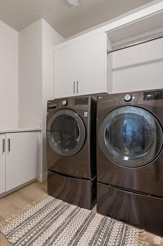 4582 S Sophia Ln, Washington, UT 84780 - laundry room with cabinet space, separate washer and dryer, and light wood-style floors