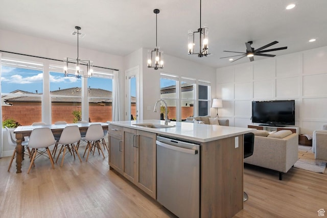 4582 S Sophia Ln, Washington, UT 84780 - kitchen featuring light wood-type flooring, open floor plan, dishwasher, ceiling fan with notable chandelier, and a sink