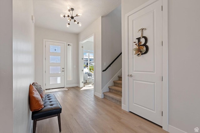4582 S Sophia Ln, Washington, UT 84780 - foyer entrance with baseboards, light wood finished floors, a notable chandelier, and stairs