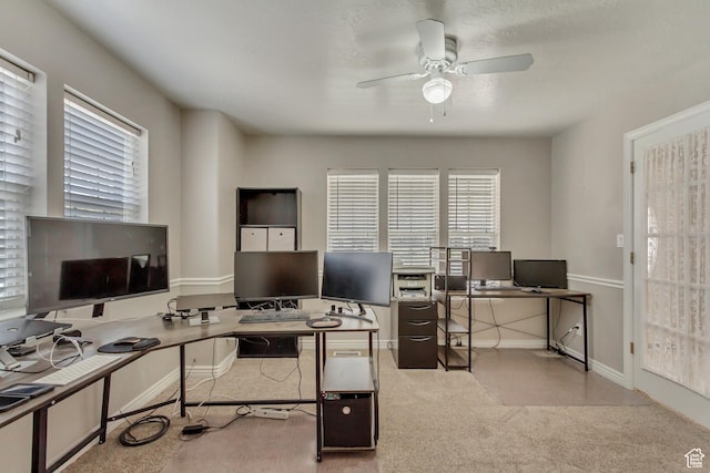 office space featuring carpet, baseboards, and ceiling fan
