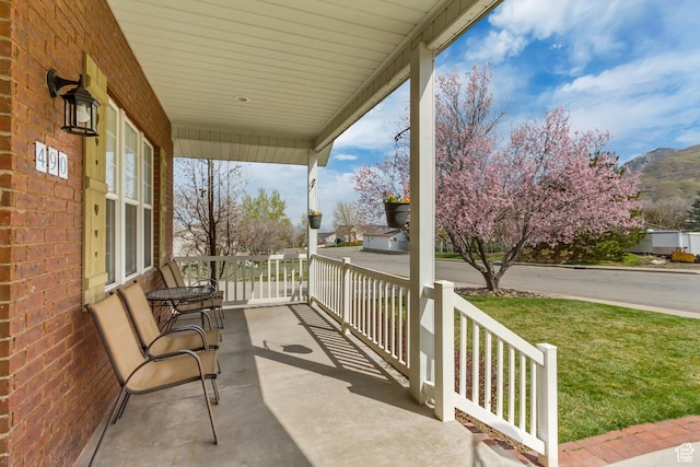 view of patio featuring a mountain view and covered porch