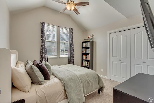 bedroom with a closet, baseboards, ceiling fan, light colored carpet, and lofted ceiling