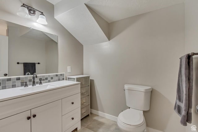 bathroom featuring baseboards, toilet, vanity, backsplash, and tile patterned flooring