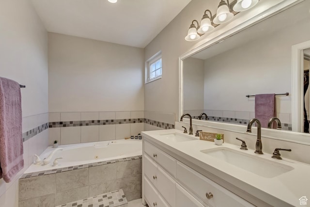 bathroom with double vanity, a bath, and a sink