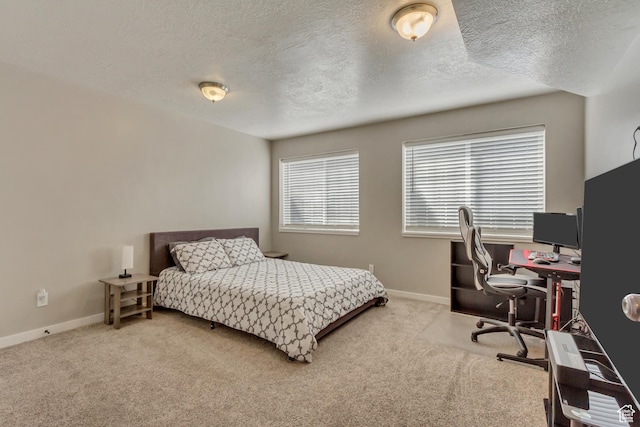 bedroom featuring baseboards, a textured ceiling, and carpet floors