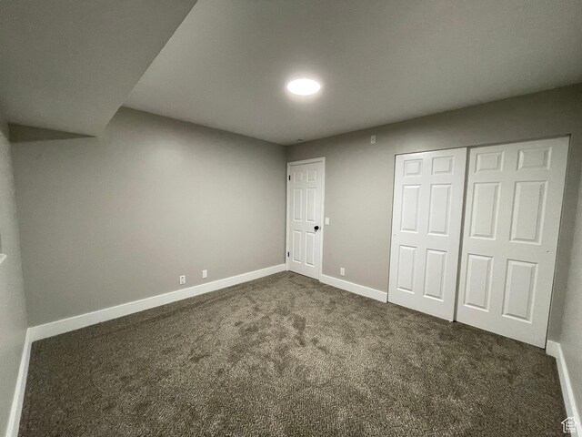 3977 W 5625 S, Roy, UT 84067 - unfurnished bedroom with baseboards, a closet, and dark colored carpet