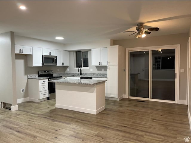 3977 W 5625 S, Roy, UT 84067 - kitchen featuring baseboards, a ceiling fan, white cabinetry, and appliances with stainless steel finishes