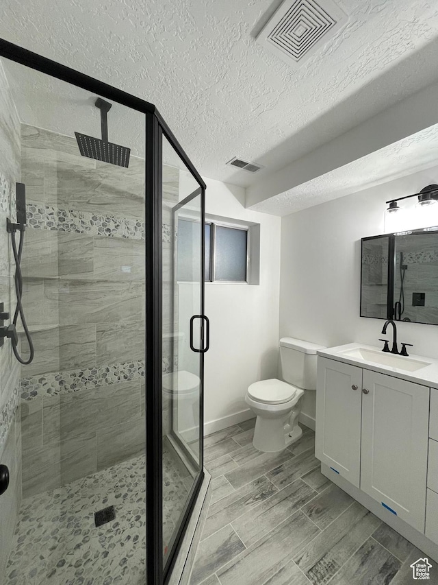 3977 W 5625 S, Roy, UT 84067 - full bath featuring toilet, a textured ceiling, visible vents, and a shower stall