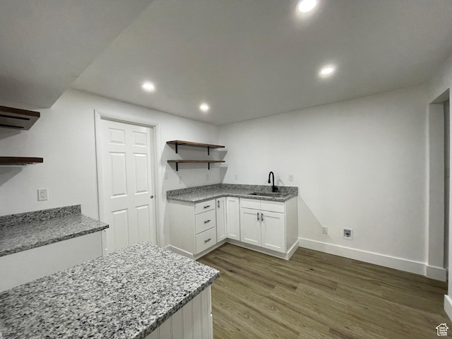3977 W 5625 S, Roy, UT 84067 - interior space featuring open shelves, wood finished floors, white cabinetry, light stone counters, and a sink