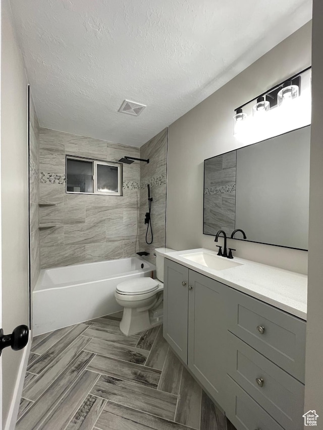 3977 W 5625 S, Roy, UT 84067 - full bathroom featuring vanity, toilet, a textured ceiling, shower / washtub combination, and visible vents