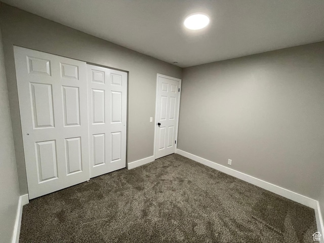 3977 W 5625 S, Roy, UT 84067 - unfurnished bedroom featuring baseboards, a closet, and dark colored carpet