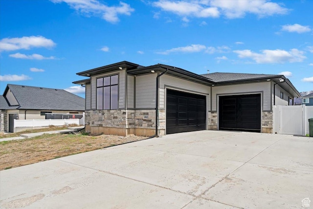 393 S Corner View Dr, Tooele, UT 84074 - view of property exterior with a garage, stone siding, and concrete driveway