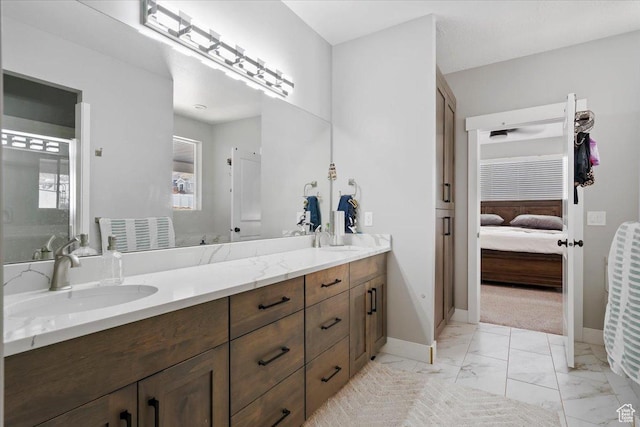 393 S Corner View Dr, Tooele, UT 84074 - ensuite bathroom featuring double vanity, marble finish floors, and baseboards