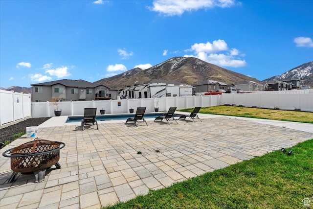 393 S Corner View Dr, Tooele, UT 84074 - fenced backyard featuring a fire pit, a residential view, a mountain view, and a patio