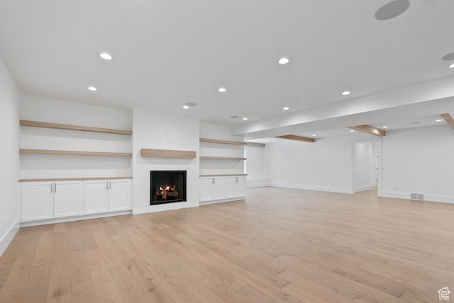 1682 N 2250 W, Provo, UT 84604 - unfurnished living room with visible vents, a large fireplace, light wood-type flooring, baseboards, and recessed lighting