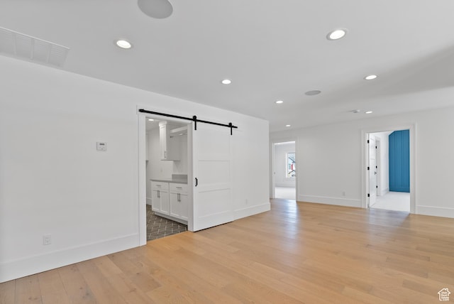 1682 N 2250 W, Provo, UT 84604 - spare room featuring baseboards, visible vents, a barn door, and light wood-style flooring