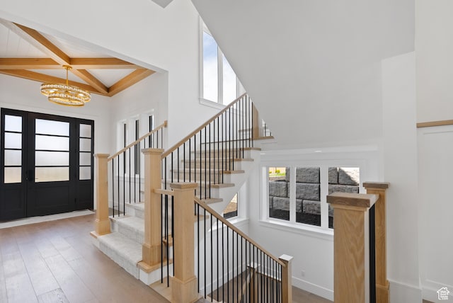 1682 N 2250 W, Provo, UT 84604 - stairway featuring a towering ceiling, wood finished floors, beamed ceiling, baseboards, and a chandelier