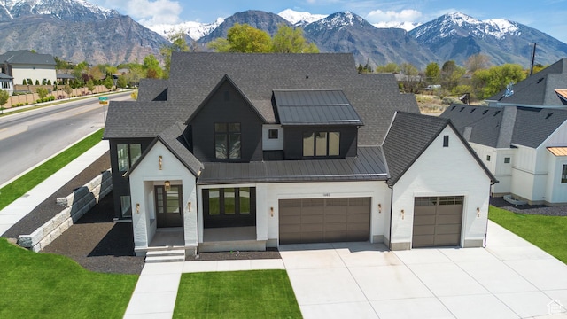 1682 N 2250 W, Provo, UT 84604 - view of front facade with an attached garage, a mountain view, a standing seam roof, driveway, and metal roof
