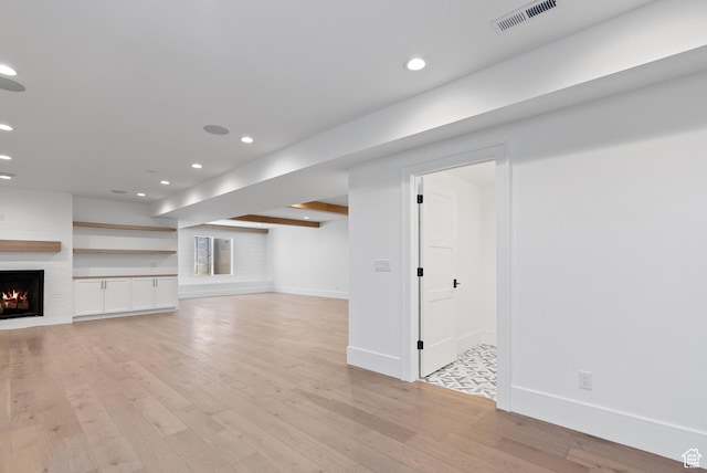1682 N 2250 W, Provo, UT 84604 - below grade area featuring visible vents, a large fireplace, light wood-type flooring, baseboards, and recessed lighting