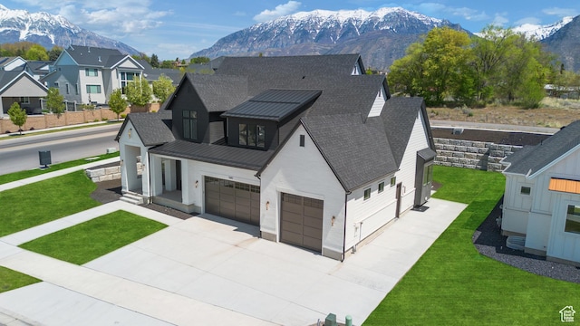 1682 N 2250 W, Provo, UT 84604 - view of front of home with concrete driveway, a mountain view, and roof with shingles