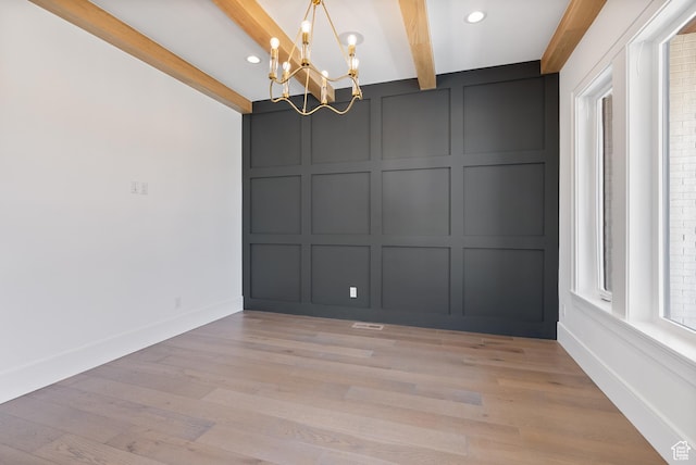 1682 N 2250 W, Provo, UT 84604 - unfurnished room with a notable chandelier, a decorative wall, light wood-style flooring, baseboards, and beamed ceiling