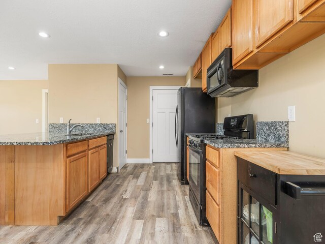 8915 E 33550 N, Fairview, UT 84629 - kitchen featuring recessed lighting, light wood-style floors, black appliances, and dark stone counters