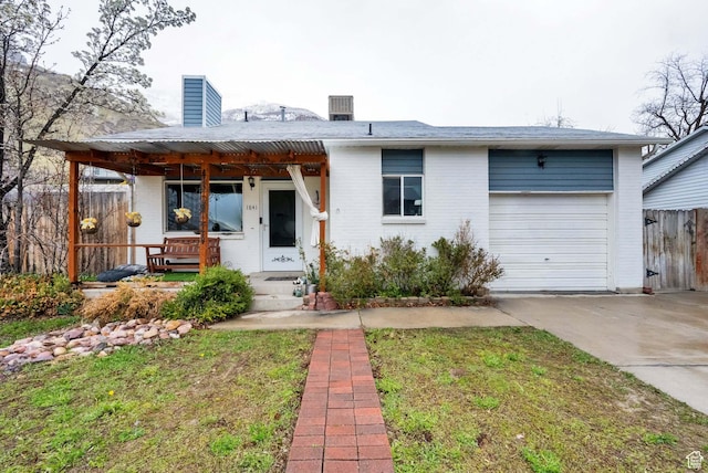 1841 S Nevada Ave, Provo, UT 84606 - view of front of property featuring concrete driveway, a chimney, an attached garage, and brick siding