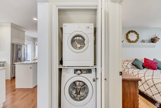 3895 S Grindstone Dr, Springville, UT 84663 - laundry room with stacked washer and dryer, light wood-style floors, and laundry area