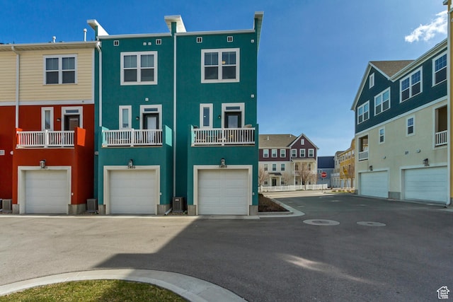 back of property with stucco siding, a residential view, and central AC