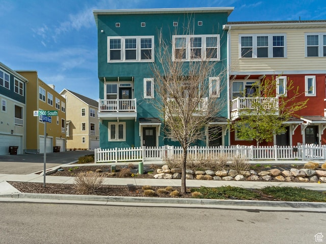 view of property with a fenced front yard and stucco siding